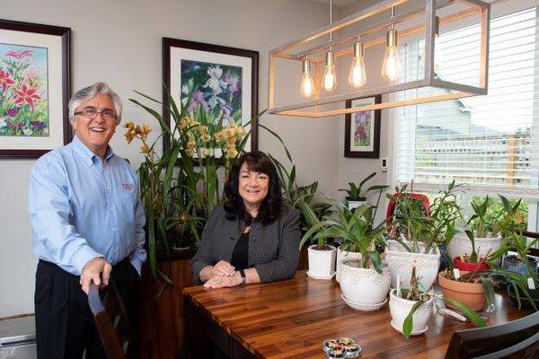 Patti Gage and Rob too in front of part of Patti's Orchid Collection