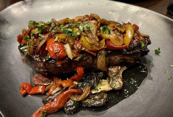 New York Strip with a nice mushrooms, peppers and potatoes topping.