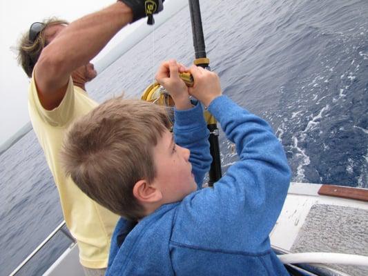 Captain Tim helping with Dawson's First Mahi-Mahi