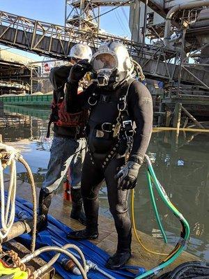 Commercial divers preparing for marine project.