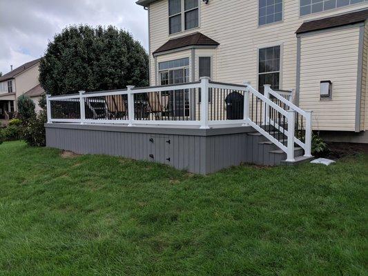 Trex decking with white vinyl rails and aluminum balusters