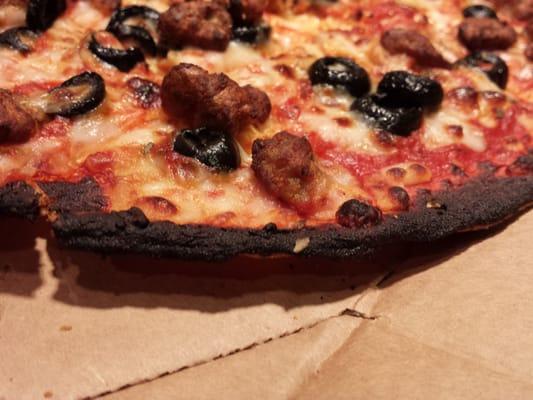 Delivery pizza burned to charcoal.