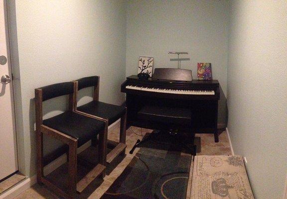 Waiting room with Korg digital piano for students to warm up and free WiFi.