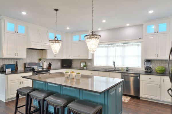 white cabinets with teal island