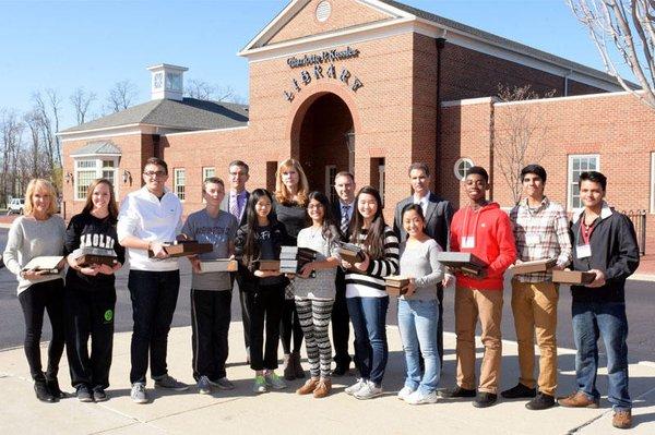 New Albany Community Foundation donors Cindy and Keith Berend with central Ohio students placing notable documents on individ...