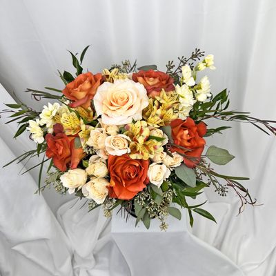 Peaches and rusts accent this seasonal fresh floral arrangement that is sure to please its recipient.