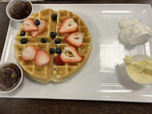 Belgian waffle  Strawberries , blueberries , whipped cream, butter , syrup