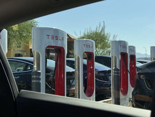 Tesla charging station that has plenty of stalls.