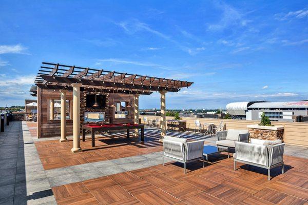 Rooftop pool table, fireplace, lounge seating, fire pits