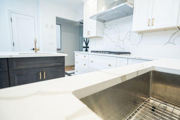 White upper cabinets with brass handles