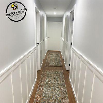 Wood accent in hallway installed, painted walls and trim. Bedroom doors and ceiling painted