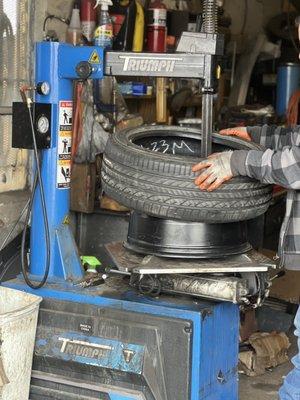 Owner installing new tire on rim.