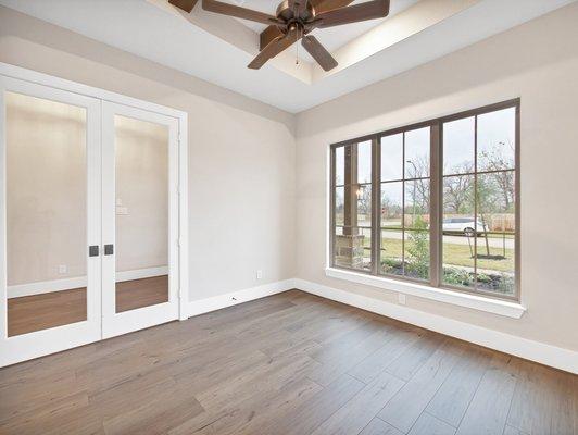 The Study - a well-lit private retreat with French doors located off of foyer