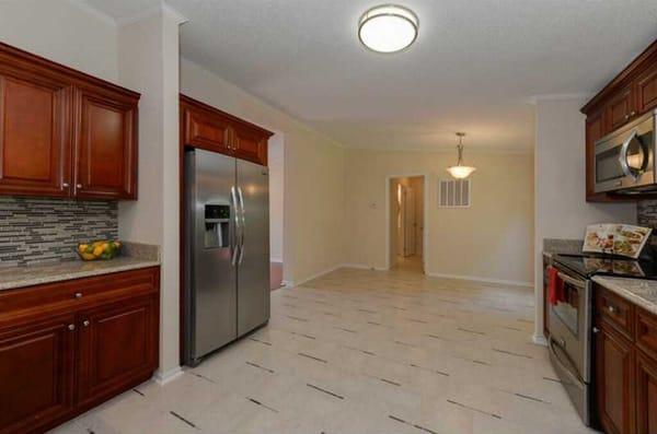 Cherry Cabinets and Desert Gold Granite by Global Home Decor.