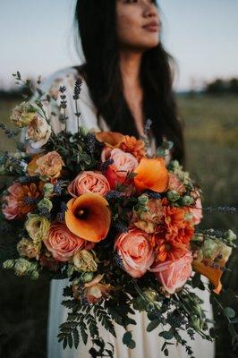 Naturally flowing peach and bronze bouquet with a touch of lavender