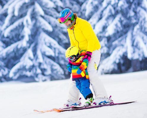 A family moment on the mountain with Hanging Lake Adventure Co-op's adult and kid ski rentals.