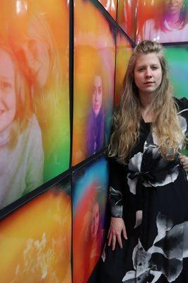 Aura Weaver founder, Charlotte Watts, in her gallery showing the auras of women of Atlanta, "Colorful You".