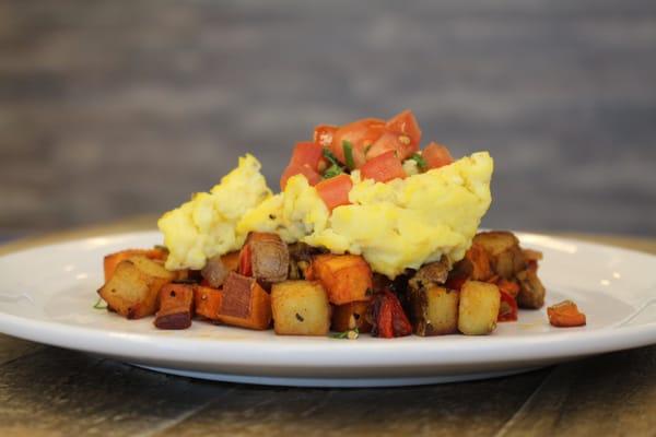 Mixed country potatoes topped with scrambled eggs