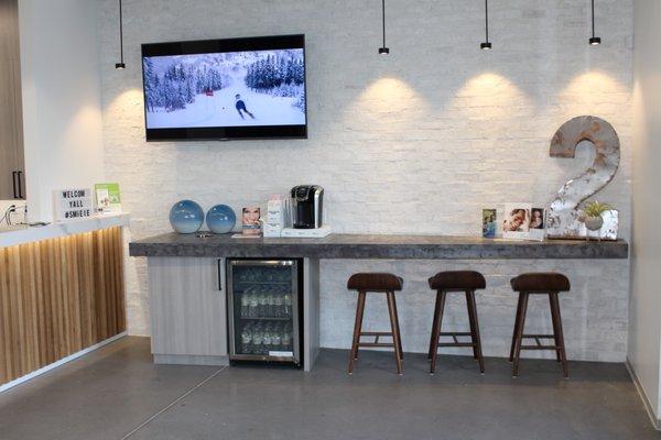 More of the reception area with beverage bar and television.