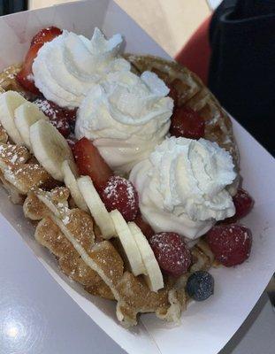 Hot waffle with fresh fruit and topped with whipped cream.