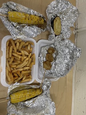 2x corn, 3 thin slices of potato on a stick, half of potato and 2 sides of fries (they put it into 1 box without asking me).