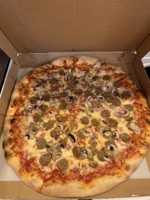 Large pie with sausage, mushroom and onion