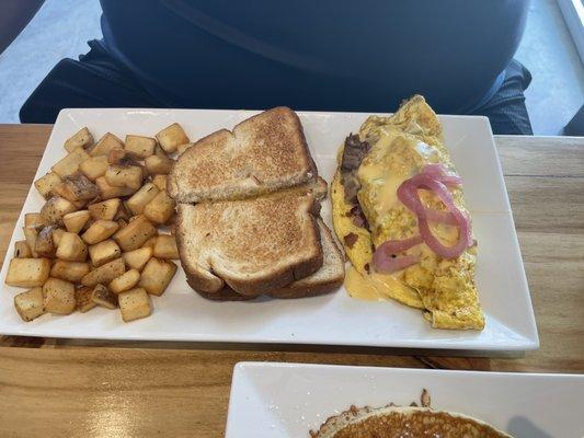 Yummy all meat omelette with potatoes and toast