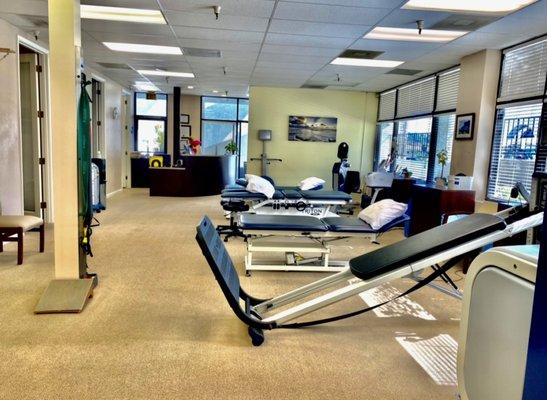 Here we have two treatment tables, one traction table and one total gym all in an open office setting.