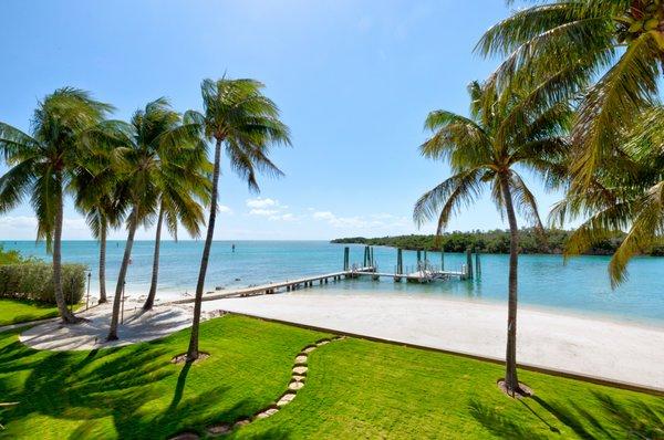 White sand beach, grass, palm trees, boat dock, Atlantic ocean inlet, Florida Keys