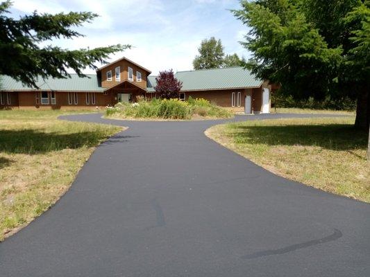 Crack filled and seal coated asphalt driveway.