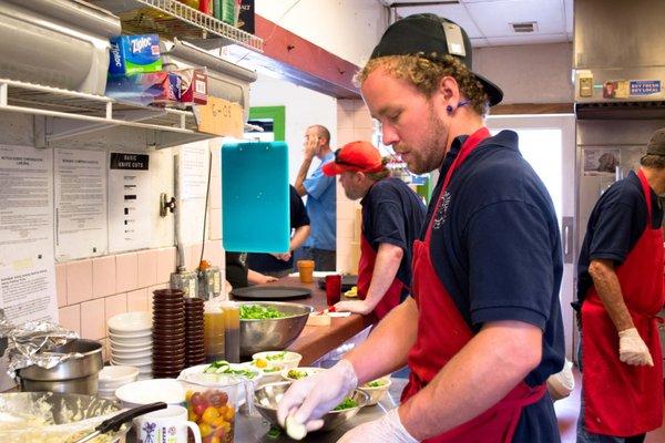 Volunteer David hard at work during our Friday Lunch Restaurant, crafting some beautifully arranged appetizers.