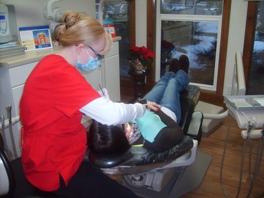 Summer our hygienist is working on a patient.