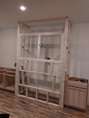 Frame out and cabinet set early stage of fireplace build.