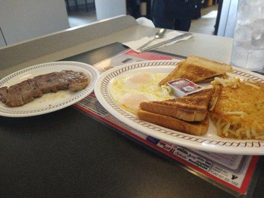 Steak and eggs with a side of hash browns and toast