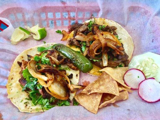 Carne asada and al pastor with grilled onions