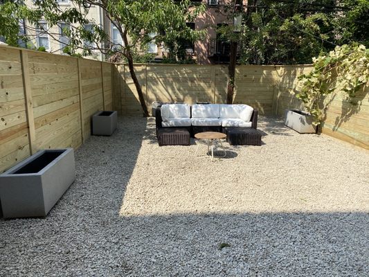 lateral fence with capping, crushed bluestone installed on top of weed barrier.