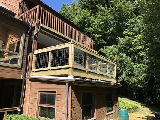 Installed a metal roof and then built a deck and railing above it.