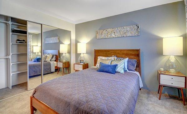 Large master suite with mirrored closet doors at Beacon at Center Apartments in Everett WA