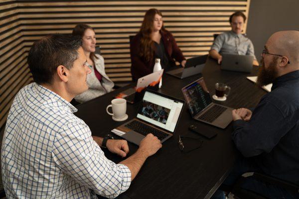 The Juxt Marketing team working together at our conference table