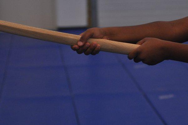 Kids and adults learn to work with bokken (wooden sword) and jo (wooden staff)