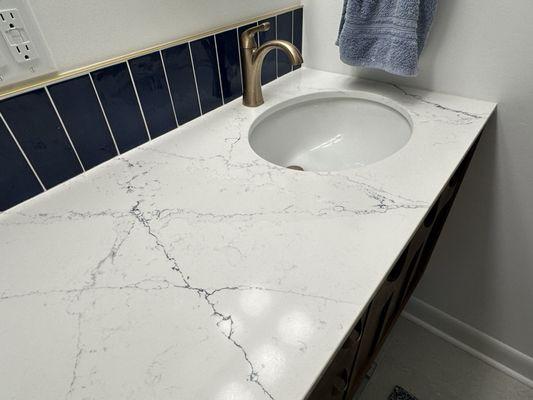 Close up of the countertop in the bath; see blue and gray marbling.