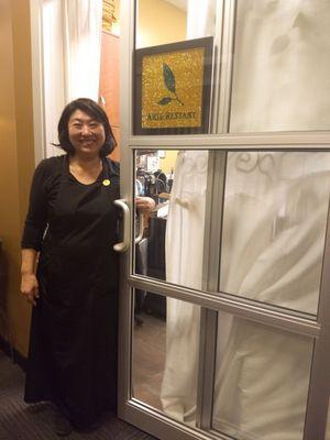 Akie standing by the front door with the gorgeous Swarovski logo sign