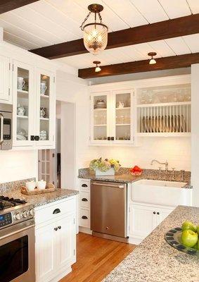 Another renovated kitchen, including multiple storage solutions and exposed beams.