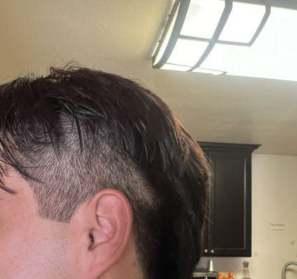 The reference photo was show it was 1 inch from the ear but he decided to shave of the whole both sides of his head.