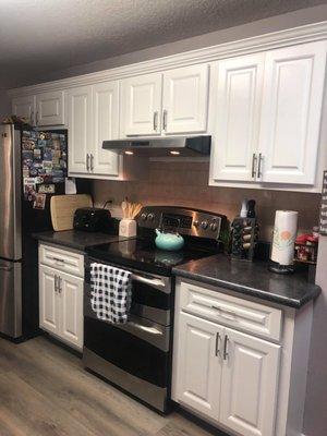 Resurfaced Cabinets stove wall. Added Crown Molding. New Countertop.