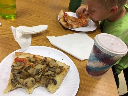 Slices of cheese and white pizza with a whole bushel of mushrooms