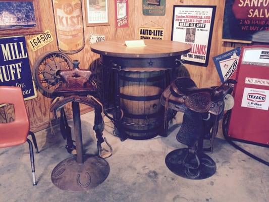 Table for sale. Yes, those are guns ( decorative only) and saddles as seat.