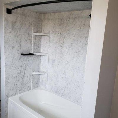 Arctic White Marble 3 wall system with deep soaking tub.