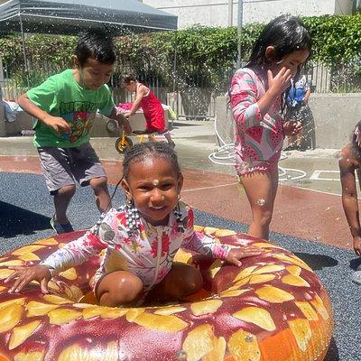 Cooling off with friends in the courtyard playground.