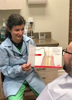 Andrezza, our hygienist reviewing periodontal probings and proper hygiene care